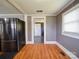 Mud room with stainless steel refrigerator and wood floors leading to the backyard at 225 N Main St, Mount Pleasant, NC 28124