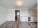 Bright storage room with white cabinets and wood flooring at 225 N Main St, Mount Pleasant, NC 28124