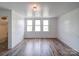 Bright white room with three windows and wood flooring at 225 N Main St, Mount Pleasant, NC 28124