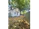 Fenced backyard featuring a large tree and a back door with a small stoop at 229 W Gray Ave, Mooresville, NC 28115