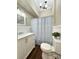 Bright bathroom features beadboard walls and updated fixtures at 229 W Gray Ave, Mooresville, NC 28115