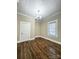 A bedroom offering hardwood floors, new paint, a door, and a double hung window at 229 W Gray Ave, Mooresville, NC 28115