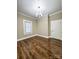 Bedroom featuring hard wood floors, neutral paint, base moulding and a door leading to another room at 229 W Gray Ave, Mooresville, NC 28115