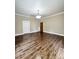 Open bedroom with hardwood floors and modern sliding barn door at 229 W Gray Ave, Mooresville, NC 28115