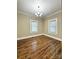 This bedroom features new vinyl floors, neutral paint, a modern light fixture, and two windows at 229 W Gray Ave, Mooresville, NC 28115