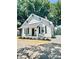 Charming renovated home with a welcoming front porch and tidy landscaping features at 229 W Gray Ave, Mooresville, NC 28115