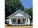 Charming renovated home with a welcoming front porch and tidy landscaping features at 229 W Gray Ave, Mooresville, NC 28115