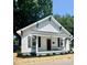 Charming renovated home with a welcoming front porch and tidy landscaping features at 229 W Gray Ave, Mooresville, NC 28115