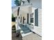Inviting front porch with a classic white bench, window boxes, and freshly landscaped yard at 229 W Gray Ave, Mooresville, NC 28115