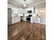 Modern kitchen with white cabinets, stainless steel appliances, and beautiful wood flooring at 229 W Gray Ave, Mooresville, NC 28115
