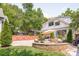 An inviting backyard featuring a stone fire pit, patio furniture, and a well-maintained lawn at 2304 Commonwealth Ave, Charlotte, NC 28205