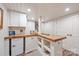 Basement bar area features a wooden countertop, white cabinets, and a mini fridge, perfect for entertaining at 2304 Commonwealth Ave, Charlotte, NC 28205