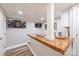Basement bar area features a wooden countertop, white cabinets, a dartboard and space for entertaining at 2304 Commonwealth Ave, Charlotte, NC 28205