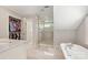 Luxurious bathroom showcasing a marble walk-in shower, freestanding tub, and a spacious walk-in closet at 2304 Commonwealth Ave, Charlotte, NC 28205