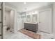 Elegant main bathroom with dual sink vanity, glass enclosed shower, and marble floors at 2304 Commonwealth Ave, Charlotte, NC 28205
