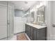 Beautiful bathroom featuring a glass shower and a double sink vanity with marble countertops at 2304 Commonwealth Ave, Charlotte, NC 28205