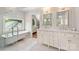 Bright bathroom featuring a freestanding tub, a double sink vanity with marble countertops, and stylish fixtures at 2304 Commonwealth Ave, Charlotte, NC 28205