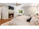 Cozy bedroom with a brick fireplace, hardwood floors, and ample natural light for a relaxing retreat at 2304 Commonwealth Ave, Charlotte, NC 28205