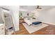 Bright bedroom featuring hardwood floors, neutral decor, and large windows at 2304 Commonwealth Ave, Charlotte, NC 28205