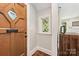 Charming entry foyer featuring a unique wooden door and diamond lattice window at 2304 Commonwealth Ave, Charlotte, NC 28205