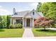 Charming home featuring a manicured lawn, walkway, light brick, mature landscaping, and a striking Japanese Maple at 2304 Commonwealth Ave, Charlotte, NC 28205