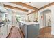 Gourmet kitchen featuring hardwood floors, a large kitchen island, stainless appliances and a view to the Gathering room at 2304 Commonwealth Ave, Charlotte, NC 28205