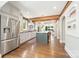 Spacious kitchen featuring stainless steel appliances, island, hardwood floors, and brick accent wall at 2304 Commonwealth Ave, Charlotte, NC 28205