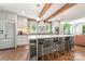 Bright kitchen with stainless steel appliances, large island, exposed brick and wooden beams at 2304 Commonwealth Ave, Charlotte, NC 28205