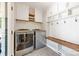 Convenient laundry room with washer, dryer, built-in shelving, and a bench, blending functionality with style at 2304 Commonwealth Ave, Charlotte, NC 28205