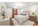 Serene main bedroom with wallpaper accent wall, statement lighting, and a plush rug at 2304 Commonwealth Ave, Charlotte, NC 28205