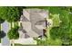 Beautiful home featuring mature trees, a spacious backyard, and an outdoor patio area with blue patio furniture at 2817 Bevis Ln, Waxhaw, NC 28173