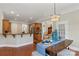 Open concept featuring wood floors, bar height kitchen counter, and modern dining area at 2817 Bevis Ln, Waxhaw, NC 28173