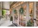 Charming entryway with double glass doors adorned with wreaths, stone facade, and cozy front porch at 2817 Bevis Ln, Waxhaw, NC 28173