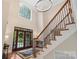 Grand foyer with high ceilings, elegant chandelier, staircase and large windows at 2817 Bevis Ln, Waxhaw, NC 28173