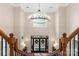 Grand two-story foyer featuring a stunning chandelier, a large window, and an elegant wooden staircase at 2817 Bevis Ln, Waxhaw, NC 28173