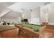 This game room features a pool table, hardwood floors, and a comfortable seating area with ample natural light at 2817 Bevis Ln, Waxhaw, NC 28173