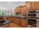 Kitchen featuring wooden cabinets, granite countertops, tile backsplash, and stainless steel appliances at 2817 Bevis Ln, Waxhaw, NC 28173