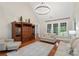 Bright living room boasting hardwood floors, statement chandelier and large windows offering natural light at 2817 Bevis Ln, Waxhaw, NC 28173