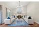 Bright living room featuring fireplace, hardwood floors, modern lighting, and stylish furniture at 2817 Bevis Ln, Waxhaw, NC 28173