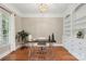 A home office with built-in bookcase, stylish desk and view to the window at 2817 Bevis Ln, Waxhaw, NC 28173