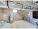 Unfinished basement with exposed brick and ductwork, along with hot water heater at 300 W Thomas St, Salisbury, NC 28144