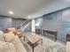 Finished basement with a brick accent wall, carpet, and furniture at 300 W Thomas St, Salisbury, NC 28144