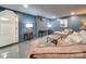 Stylish basement living area with blue painted walls, soft rug, and a brick accent wall at 300 W Thomas St, Salisbury, NC 28144