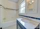 Bathroom featuring a tub with shower, vanity with marble countertop, and black & white tiled floor at 300 W Thomas St, Salisbury, NC 28144
