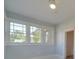 Bright bedroom featuring light blue walls and three large grid-style windows at 300 W Thomas St, Salisbury, NC 28144