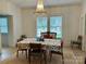 Bright dining room featuring a chandelier, floral table cover and plenty of natural light at 300 W Thomas St, Salisbury, NC 28144