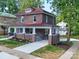 Two-story brick home boasts a classic design with a charming front porch, blending traditional architecture with modern comfort at 300 W Thomas St, Salisbury, NC 28144