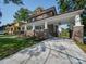 View of brick home with covered parking and manicured landscaping, creating a welcoming and functional outdoor space at 300 W Thomas St, Salisbury, NC 28144