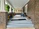Charming front porch with brick facade and cozy seating, a perfect relaxation spot at 300 W Thomas St, Salisbury, NC 28144