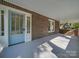 Inviting front porch with brick accents and a blue door, creating a warm and welcoming entrance to the home at 300 W Thomas St, Salisbury, NC 28144